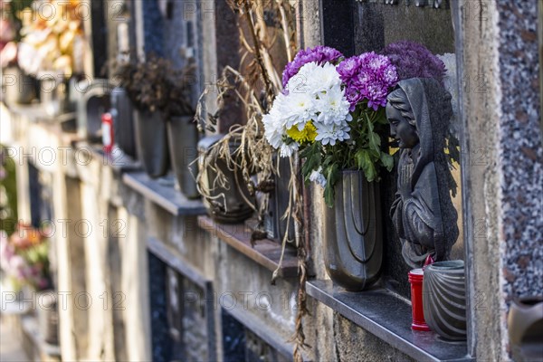 Wall with decorated urns graves in a cemetery in Sardinia