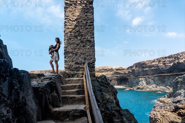 A young woman with her son in the Cuevas de Ajuy