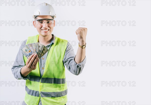 Happy engineer holding money celebrating isolated. Excited engineer holding banknotes and celebrating an award isolated