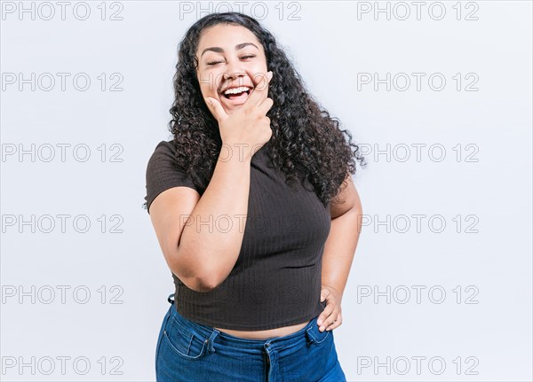 Happy young latin woman holding chin laughing isolated. Portrait of funny latin woman smiling isolated. Portrait of young woman nicaraguan