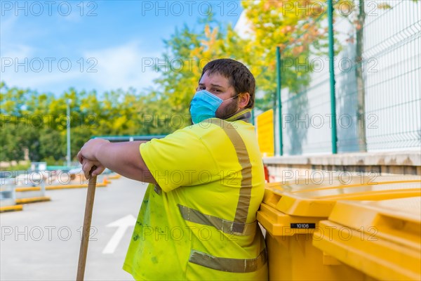 Worker in a recycling factory or clean point and garbage with a face mask and with security protections