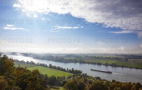 Cargo ship in the morning mist on the Danube near Regensburg