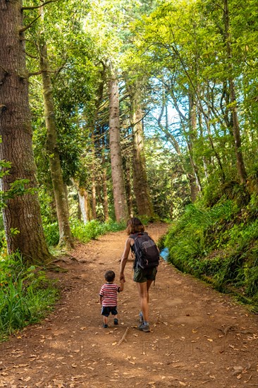 A mother with her son on the footpath at Levada do Caldeirao Verde