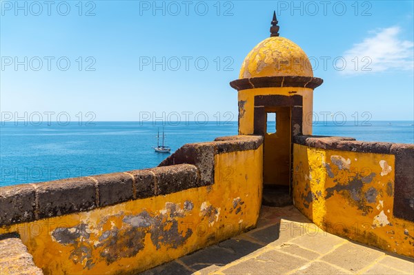 Yellow watchtower at the Forte de Sao Tiago fort in Funchal by the sea. Madeira