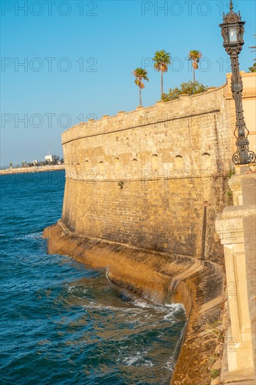 Walls and sea coast of the Baluarte de la Candelaria in the city of Cadiz. Andalusia