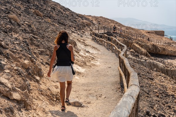 A young woman walking on the path in the Cuevas de Ajuy
