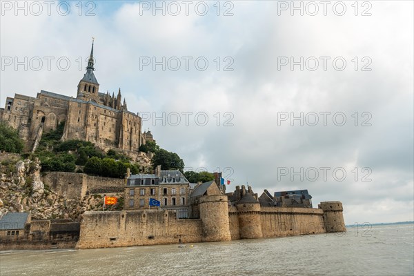 The famous Mont Saint-Michel Abbey at sunrise at high tide in the Manche department