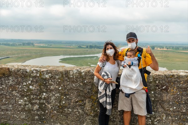 A young family visiting the famous Mont Saint-Michel Abbey from inside