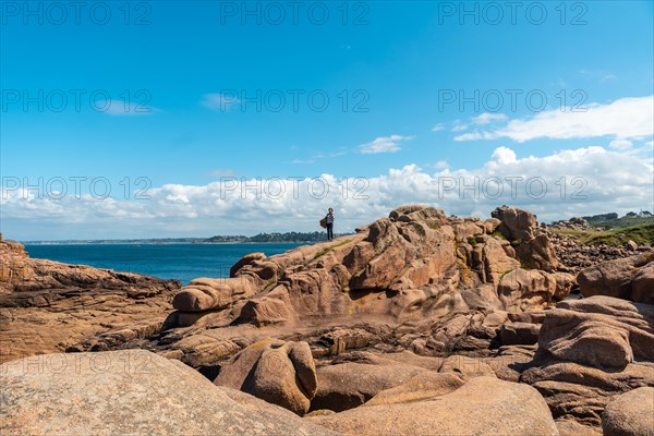 A young woman by the sea on the coast next to Lighthouse Mean Ruz