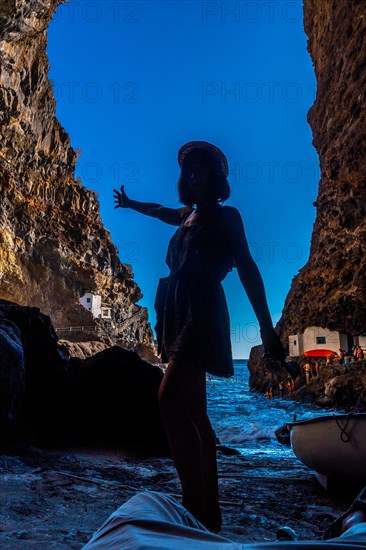 A young woman inside the cave of the town of Poris de Candelaria on the north-west coast of the island of La Palma