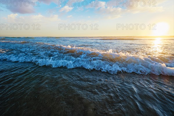 Atlantic ocean sunset with surging waves at Fonte da Telha beach