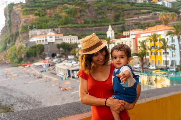 A mother and son on summer vacation at Ponta do Sol Beach