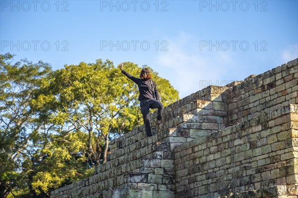 A young girl watching The ball game field in the temples of Copan Ruinas. Honduras