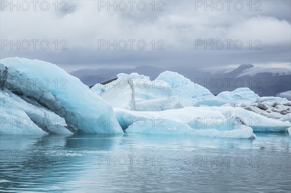 Beautiful icebergs on Jokulsarlon Ice Lake in the golden circle of southern Iceland on a cold August morning