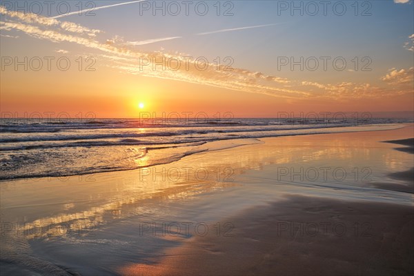 Atlantic ocean sunset with surging waves at Fonte da Telha beach