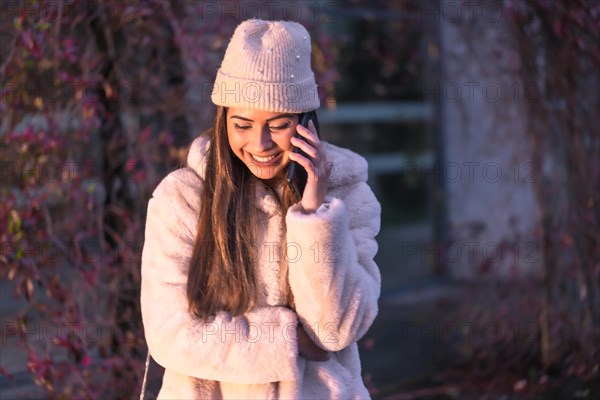 Young pretty Caucasian brunette walking in the city in winter