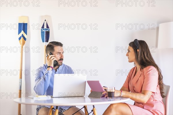 A couple teleworking at home