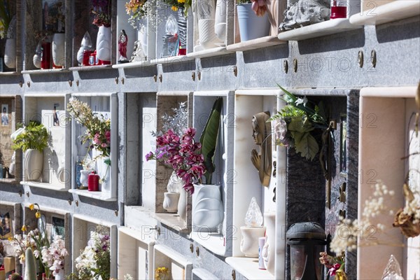 Wall with decorated urns graves in a cemetery in Sardinia