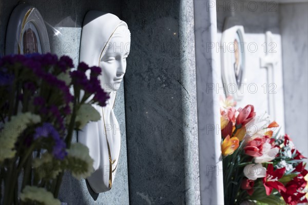 Wall with decorated urns graves in a cemetery in Sardinia