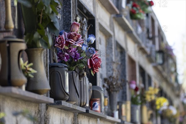 Wall with decorated urns graves in a cemetery in Sardinia