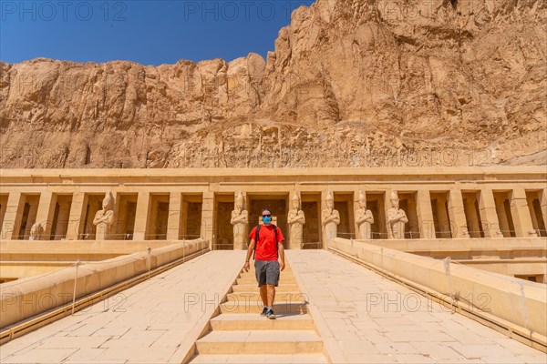 A young woman on the entrance stairs to the Funerary Temple of Hatshepsut in Luxor. Egypt