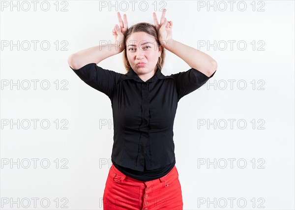 People making horns gesture with their fingers
