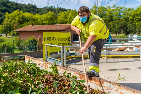 Worker in a recycling factory or clean point and garbage with a face mask and with security protections