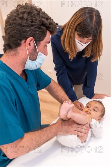 Vertical photo of a mother and baby during a checkup in the hospital