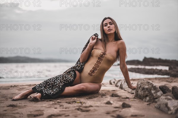 Portrait of a brunette woman wearing a swimsuit on the beach in summer