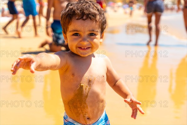 Boy playing in the sand and having fun