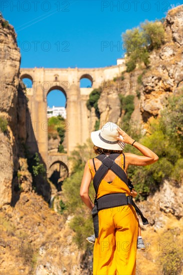 A young mother with her son at the new bridge viewpoint in Ronda Malaga province