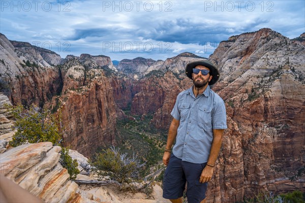 A man enjoying the views of Zion from the Angels Landing Trail in Zion National Park