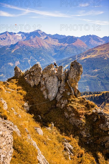 Climbers in rocky mountain landscape in autumn