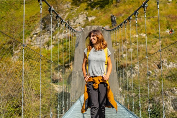 A hiker crossing the Holtzarte suspension bridge