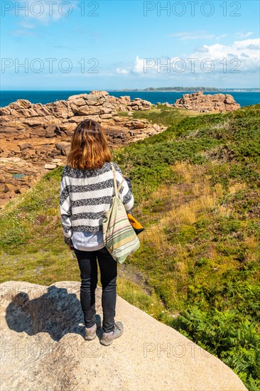 A young woman on the coast next to Lighthouse Mean Ruz