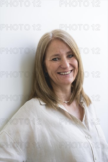 Beautiful mid aged woman looking at camera isolated on white background