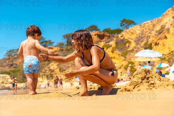 Mother and son playing on the beach at Praia do Barranco das Belharucas