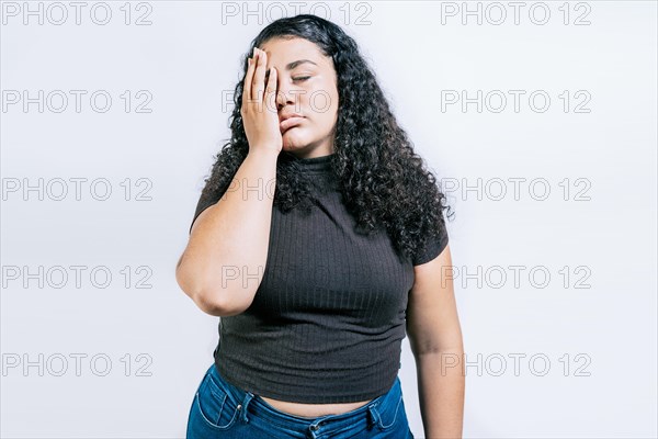 Tired and exhausted woman holding her forehead. Worried young woman holding his forehead. Exhausted woman with palm on forehead isolated