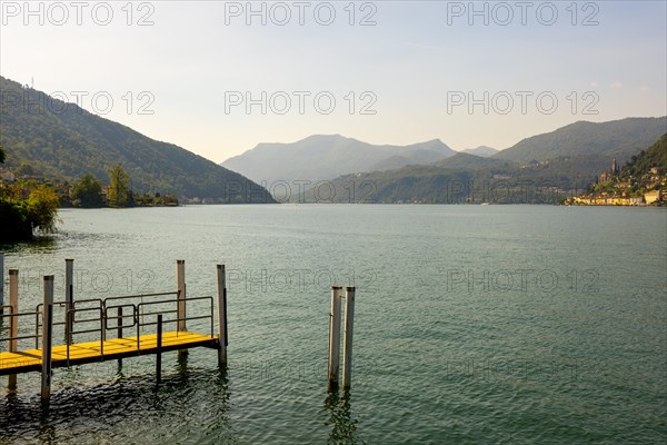 Jetty on the Waterfront in a Sunny Summer Day and with Lake Lugano and Mountain View over Morcote