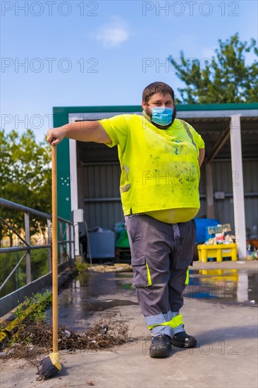 Worker in a recycling factory or clean point and garbage with a face mask and with security protections