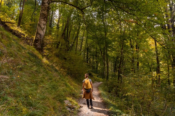 A young woman heading to Passerelle de Holtzarte de Larrau in the forest or jungle of Irati