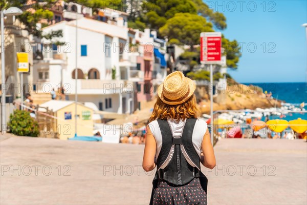 A mother with her baby on the beach of Sa Tuna on the coast of Begur in summer