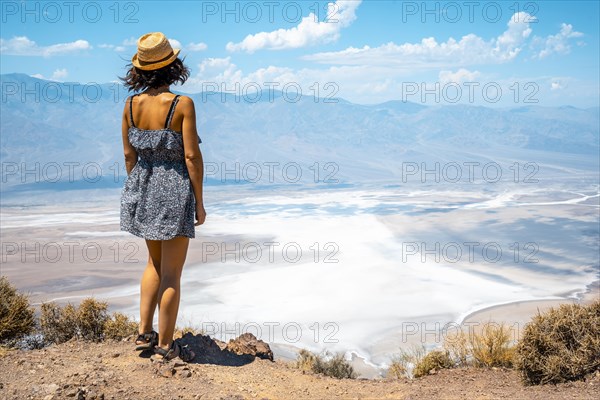 A young woman in dress on the beautiful viewpoint of Dante's view in Death Valley