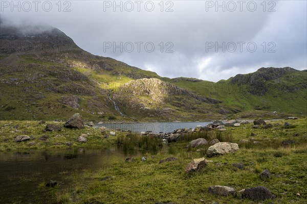 Lake Llyn Llydaw with Mount Snowdon behind clouds in late summer