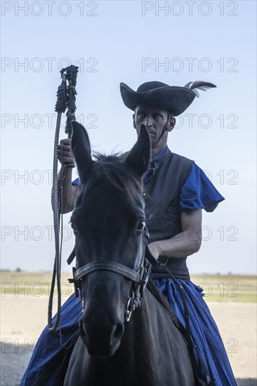 Cracking the whip with the Hungarian shepherd's whip on horseback