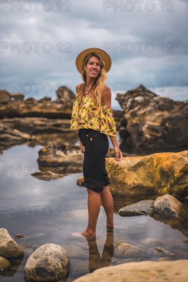 Caucasian blonde girl in a floral shirt