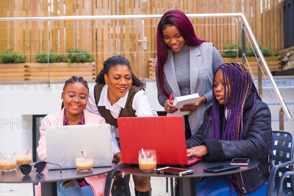 Young and alternative businesswomen of black ethnicity. In a team-building meeting