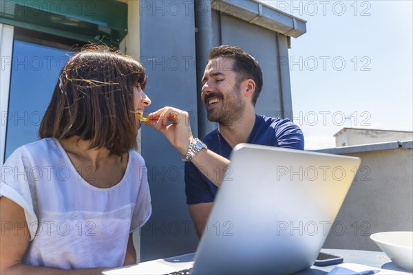 A couple confined at home making a video call with some friends with the computer