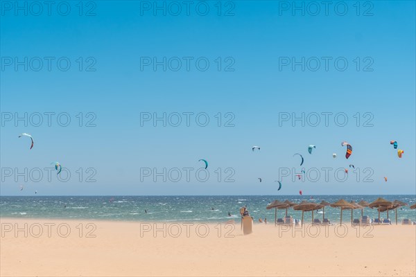 Windy morning ideal for kitesurfing on the beach. Extreme sport