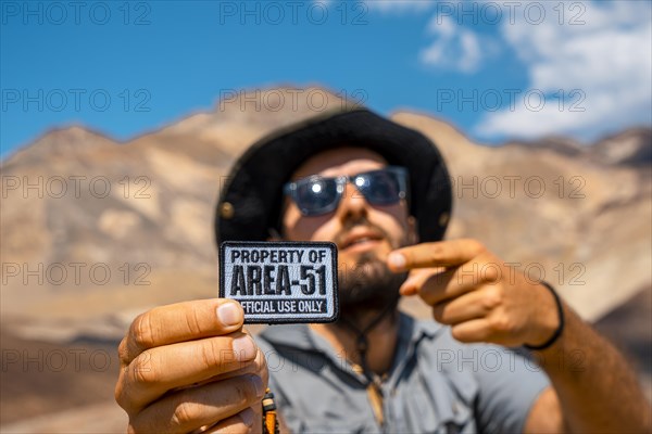 A young man with a patch for Area 51 clothing on Artist's Drive in Death Valley